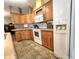 The kitchen features wooden cabinetry and modern white appliances at 37544 Corey Lewis Ave, Zephyrhills, FL 33541