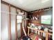 Unfinished storage room with workbench, shelving, and exposed framing at 37544 Corey Lewis Ave, Zephyrhills, FL 33541