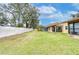 Landscaped backyard with spacious grassy area at 38351 Ironwood Pl, Zephyrhills, FL 33542