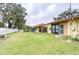 Landscaped backyard with spacious grassy area at 38351 Ironwood Pl, Zephyrhills, FL 33542