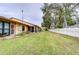 View of backyard with a large grassy area and trees at 38351 Ironwood Pl, Zephyrhills, FL 33542