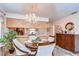 Spacious dining room features a chandelier and hardwood floors at 38351 Ironwood Pl, Zephyrhills, FL 33542