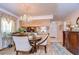 Well-lit dining area features a round table and chandelier at 38351 Ironwood Pl, Zephyrhills, FL 33542