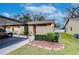 Front exterior view of home with carport and landscaping at 38351 Ironwood Pl, Zephyrhills, FL 33542