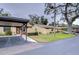 Exterior view showing a building with carport and landscaping at 38351 Ironwood Pl, Zephyrhills, FL 33542