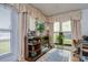 Bright sunroom with fireplace, built-in shelving, and hardwood floors at 38351 Ironwood Pl, Zephyrhills, FL 33542