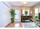 Bright sunroom featuring a fireplace, built-in shelving, and hardwood floors at 38351 Ironwood Pl, Zephyrhills, FL 33542