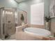 Spa-like bathroom with soaking tub and walk-in shower at 404 Manns Harbor Dr, Apollo Beach, FL 33572