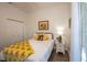 Bedroom with yellow and sunflowers decor and backyard access at 404 Manns Harbor Dr, Apollo Beach, FL 33572