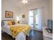 Bedroom with yellow bedding and access to backyard at 404 Manns Harbor Dr, Apollo Beach, FL 33572