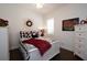 Charming bedroom with a white queen-size bed and red/black bedding at 404 Manns Harbor Dr, Apollo Beach, FL 33572