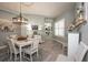 Elegant dining room with a white table and chairs, great for entertaining at 404 Manns Harbor Dr, Apollo Beach, FL 33572