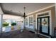 Charming front porch with a porch swing and sunflowers, welcoming entrance at 404 Manns Harbor Dr, Apollo Beach, FL 33572