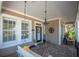 Relaxing front porch featuring a swing and hanging light fixture, inviting atmosphere at 404 Manns Harbor Dr, Apollo Beach, FL 33572