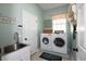 Laundry room with washer, dryer, and utility sink at 404 Manns Harbor Dr, Apollo Beach, FL 33572