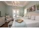 Serene main bedroom featuring a king bed and French doors to outdoor space at 404 Manns Harbor Dr, Apollo Beach, FL 33572