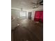 Living room with wood flooring, large window, ceiling fan and neutral walls at 404 N Oakwood Ave, Brandon, FL 33510