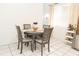 Cozy dining area with round table and four chairs, perfect for Gathering meals at 4513 W Clifton St, Tampa, FL 33614