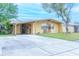 Ranch style home with a large driveway and carport at 4513 W Clifton St, Tampa, FL 33614