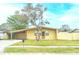 Cute yellow house with a carport and a fenced backyard at 4513 W Clifton St, Tampa, FL 33614