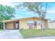 Yellow house with carport and landscaping at 4513 W Clifton St, Tampa, FL 33614