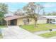 House front with driveway and landscaping at 4513 W Clifton St, Tampa, FL 33614