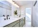 Modern bathroom with dual vanities, green cabinets, and quartz countertops at 4804 Foxshire Cir, Tampa, FL 33624