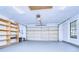 Garage with built-in shelving and freshly painted floor at 4804 Foxshire Cir, Tampa, FL 33624