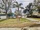 House exterior with a wide front yard and palm tree at 4865 163Rd N Ave, Clearwater, FL 33762