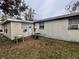 Side view of the house with a small patio area at 4865 163Rd N Ave, Clearwater, FL 33762