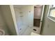 Bathroom with a patterned shower and hexagon floor tile at 502 E Cluster Ave, Tampa, FL 33604