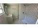 Updated bathroom with a walk-in shower and patterned tile at 502 E Cluster Ave, Tampa, FL 33604