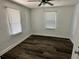 Bright bedroom with gray wood-look flooring and ceiling fan at 502 E Cluster Ave, Tampa, FL 33604