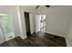 Bedroom with wood-look floors, closet, and view of the kitchen at 502 E Cluster Ave, Tampa, FL 33604