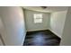 Small bedroom with dark wood-look floors and a window at 502 E Cluster Ave, Tampa, FL 33604