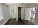 Bedroom with wood-look floors and access to the bathroom at 502 E Cluster Ave, Tampa, FL 33604