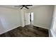 Simple bedroom with gray wood-look flooring and closet at 502 E Cluster Ave, Tampa, FL 33604