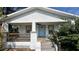 Renovated home with a covered front porch and light blue front door at 502 E Cluster Ave, Tampa, FL 33604