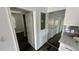 Hallway with doors to bedrooms and kitchen at 502 E Cluster Ave, Tampa, FL 33604