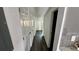 Hallway with dark wood-look floors and access to bedrooms at 502 E Cluster Ave, Tampa, FL 33604