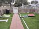 Backyard with artificial turf and a gate at 5266 6Th S Ave, St Petersburg, FL 33707