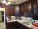 Kitchen with dark wood cabinets, granite countertops, and stainless steel appliances at 5266 6Th S Ave, St Petersburg, FL 33707