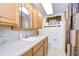 Bathroom with wood cabinets, shower, and tiled floor at 6125 Alpine Dr, Zephyrhills, FL 33542