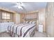 Bedroom with striped bedding, dresser, and ceiling fan at 6125 Alpine Dr, Zephyrhills, FL 33542