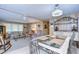 Bright dining area features a glass-topped table and charming metal chairs at 6125 Alpine Dr, Zephyrhills, FL 33542