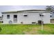 Back of the house with a view of the lawn at 6125 Alpine Dr, Zephyrhills, FL 33542