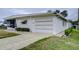 Side view of a manufactured home with carport at 6125 Alpine Dr, Zephyrhills, FL 33542