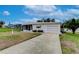 Single story home with a carport and small lawn at 6125 Alpine Dr, Zephyrhills, FL 33542