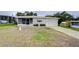 Single story home with carport and mature lawn at 6125 Alpine Dr, Zephyrhills, FL 33542