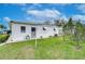 Rear view of single story home with AC unit at 6125 Alpine Dr, Zephyrhills, FL 33542